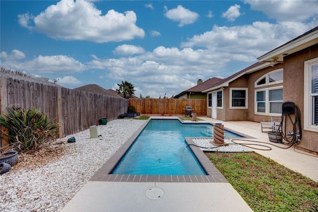 view of swimming pool with a fenced backyard, a fenced in pool, and a patio
