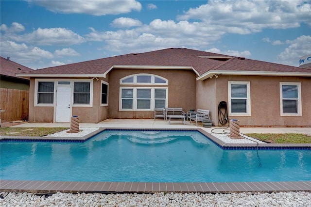 outdoor pool with a patio area and fence