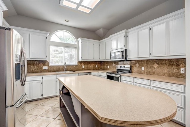 kitchen featuring appliances with stainless steel finishes, light countertops, and white cabinetry
