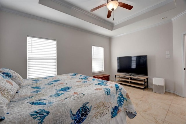 bedroom with baseboards, a tray ceiling, a ceiling fan, and crown molding