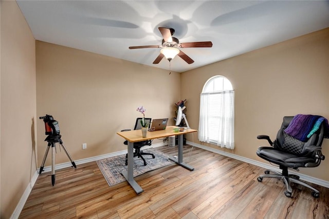 office space with ceiling fan, light wood-type flooring, and baseboards