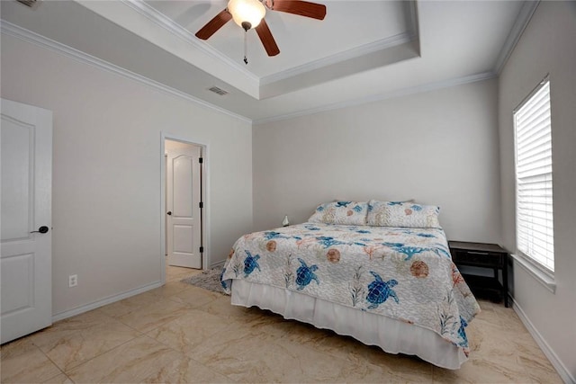 bedroom featuring baseboards, a tray ceiling, visible vents, and crown molding