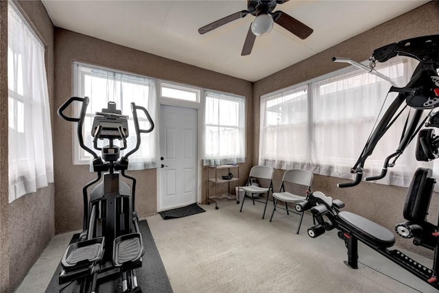 workout room with light carpet and a ceiling fan
