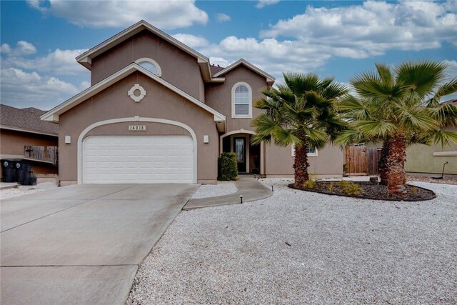 view of front of property featuring an attached garage, driveway, and stucco siding