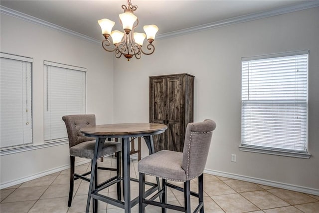dining area with light tile patterned floors, baseboards, a chandelier, and crown molding
