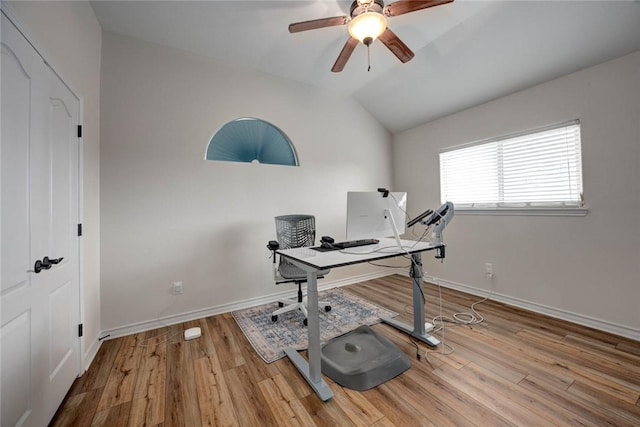 home office with vaulted ceiling, baseboards, and light wood-style floors