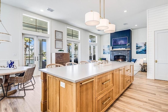 206 Lakeshore St, Port Aransas, TX 78373 - kitchen with light wood-style floors, french doors, healthy amount of natural light, and recessed lighting