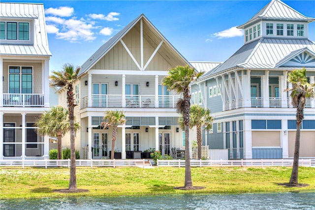 206 Lakeshore St, Port Aransas, TX 78373 - view of front facade with a standing seam roof, metal roof, and a water view