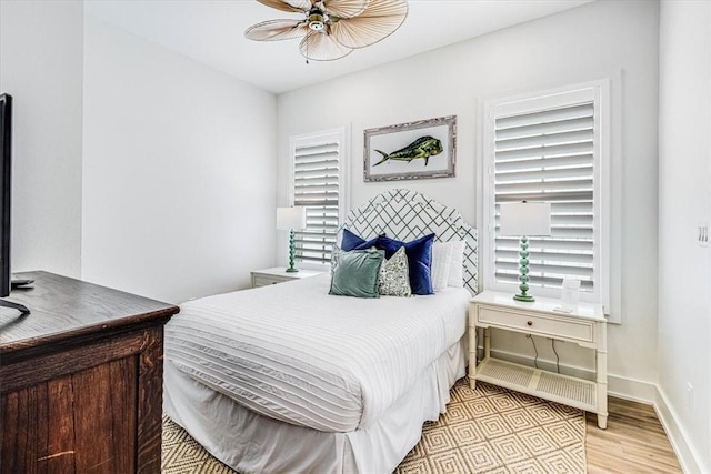 206 Lakeshore St, Port Aransas, TX 78373 - bedroom featuring light wood-style flooring, a ceiling fan, and baseboards