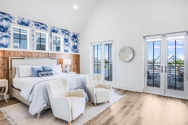 206 Lakeshore St, Port Aransas, TX 78373 - bedroom featuring access to outside, high vaulted ceiling, wood finished floors, baseboards, and recessed lighting