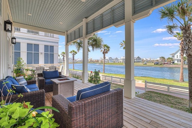 206 Lakeshore St, Port Aransas, TX 78373 - deck with an outdoor living space with a fire pit, a water view, and a residential view