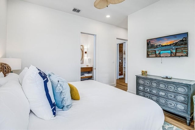 206 Lakeshore St, Port Aransas, TX 78373 - bedroom with wood finished floors, recessed lighting, ensuite bath, and baseboards