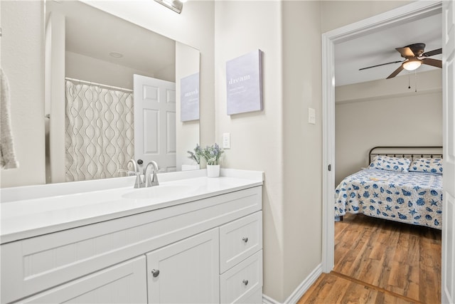 bathroom with vanity, hardwood / wood-style flooring, and ceiling fan