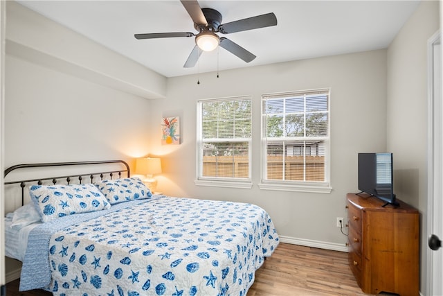 bedroom with light hardwood / wood-style floors and ceiling fan