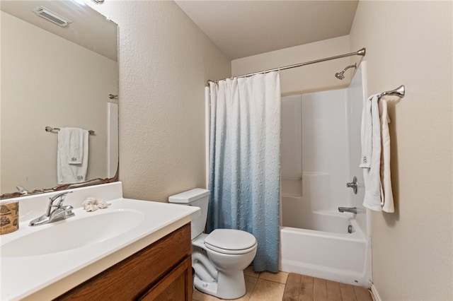 full bathroom with vanity, shower / tub combo, and toilet