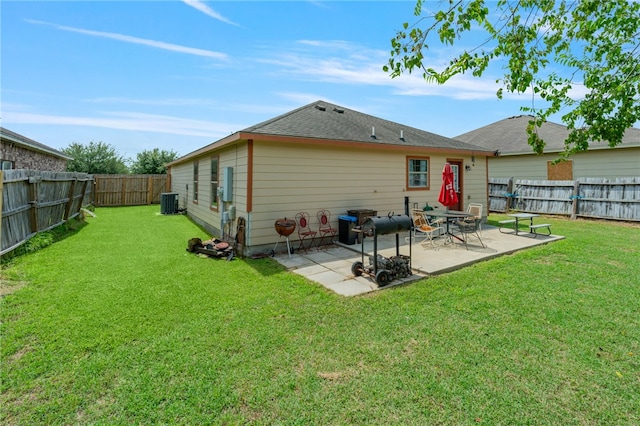 back of property featuring a yard, central AC, and a patio area