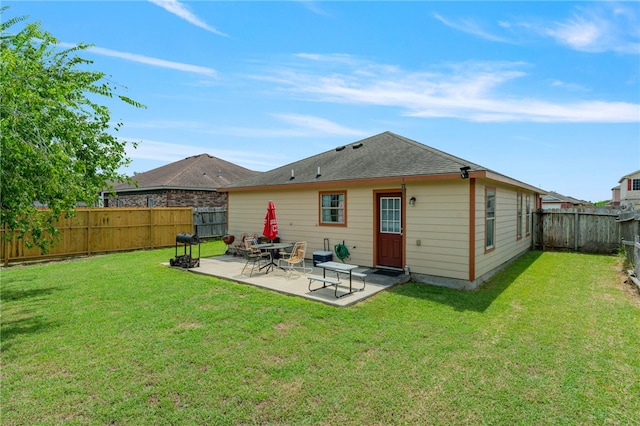 rear view of property featuring a patio and a yard