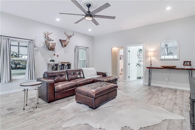 living room with ceiling fan and light hardwood / wood-style floors