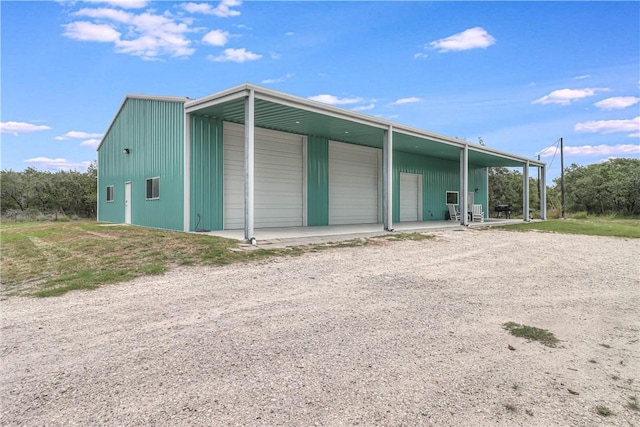 exterior space with a garage and an outdoor structure