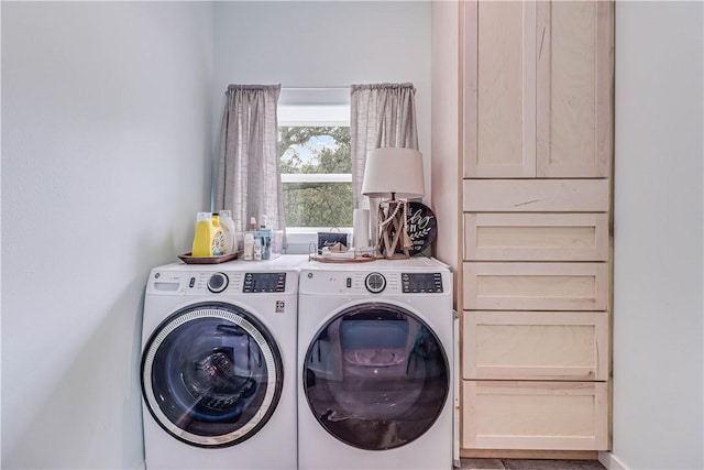 clothes washing area with washer and clothes dryer