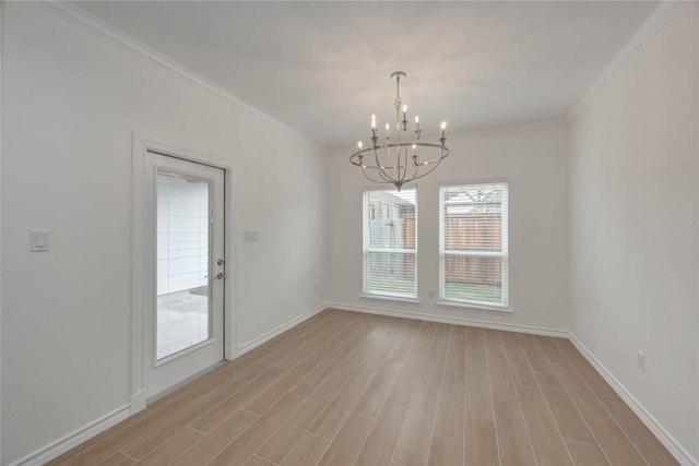 unfurnished room with a notable chandelier, light hardwood / wood-style floors, plenty of natural light, and ornamental molding