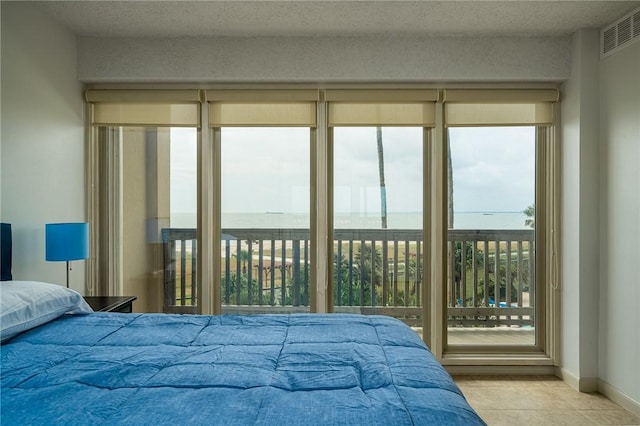 tiled bedroom with visible vents and baseboards