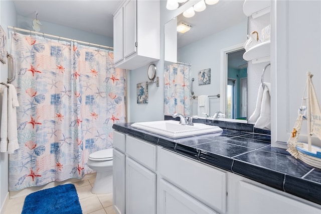 bathroom featuring tile patterned floors, vanity, and toilet