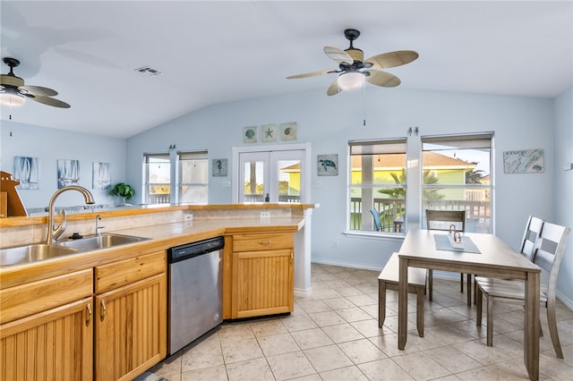 kitchen featuring french doors, vaulted ceiling, sink, light tile patterned floors, and dishwasher