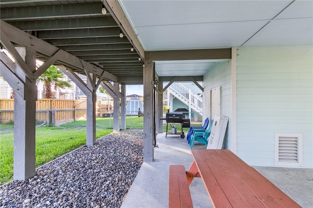 view of patio / terrace with area for grilling and a storage shed