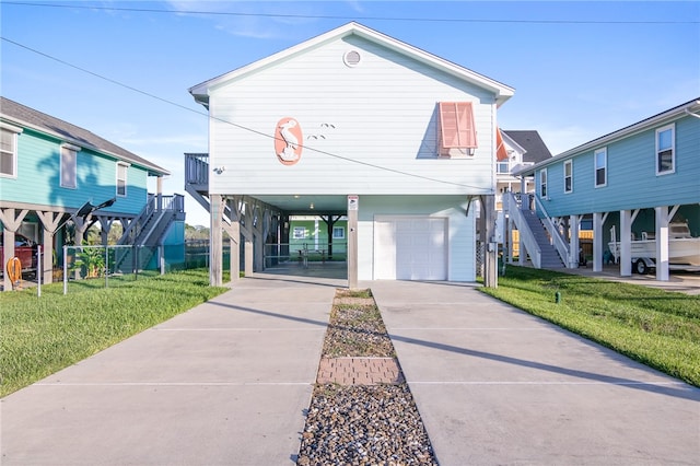 beach home with a carport, a garage, and a front lawn