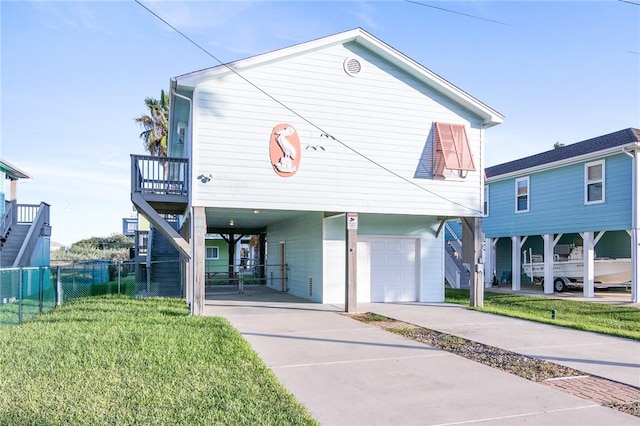 1224 S Live Oak St, Rockport, TX 78382 - raised beach house with a carport, a garage, and concrete driveway