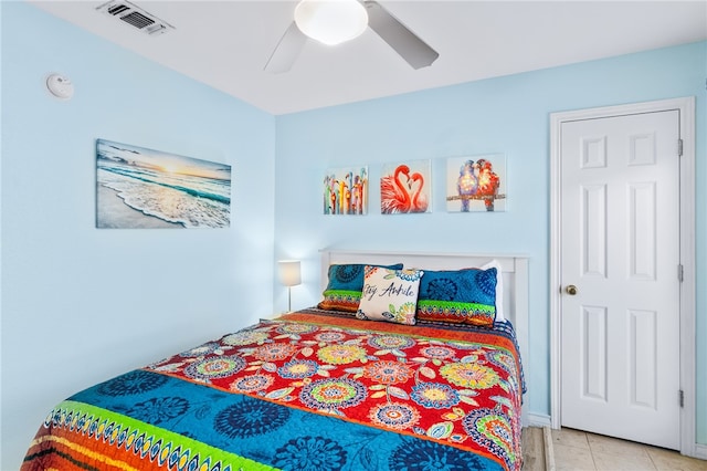 tiled bedroom with ceiling fan