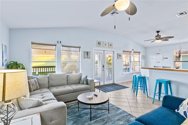 tiled living room with ceiling fan and lofted ceiling