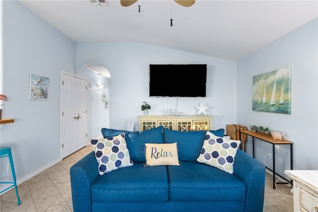 living room with vaulted ceiling, ceiling fan, and light tile patterned flooring