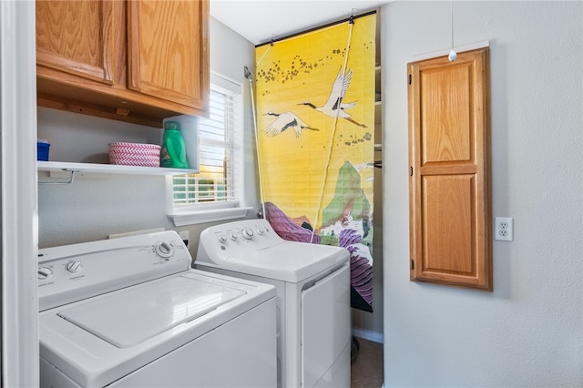 washroom with cabinets and washing machine and dryer