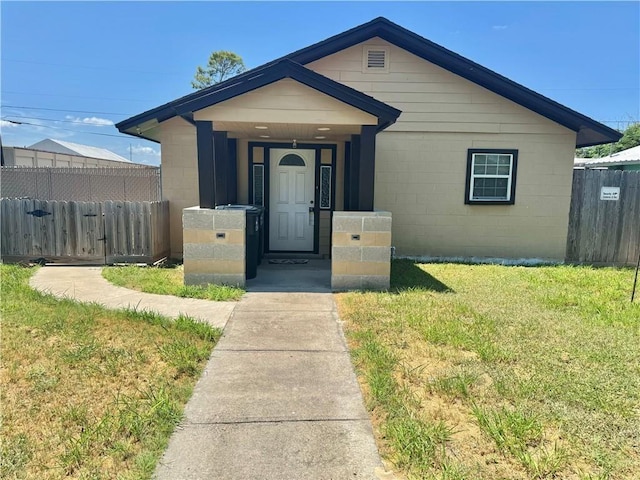 bungalow-style house with a front lawn