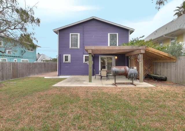 rear view of house with a lawn, a patio area, and a pergola