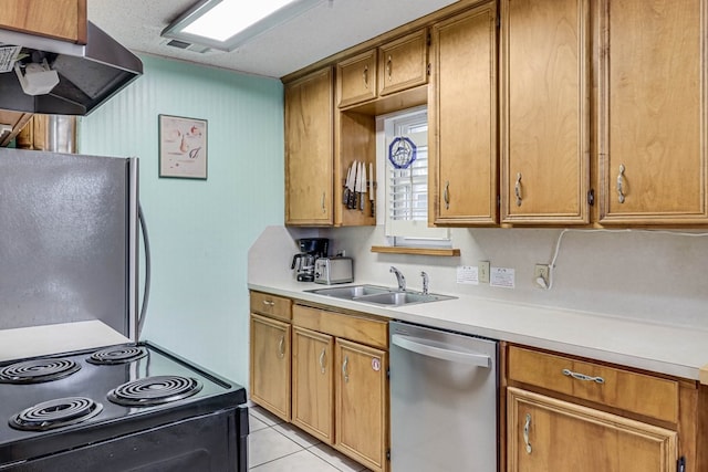 kitchen featuring exhaust hood, sink, light tile patterned floors, a textured ceiling, and stainless steel appliances