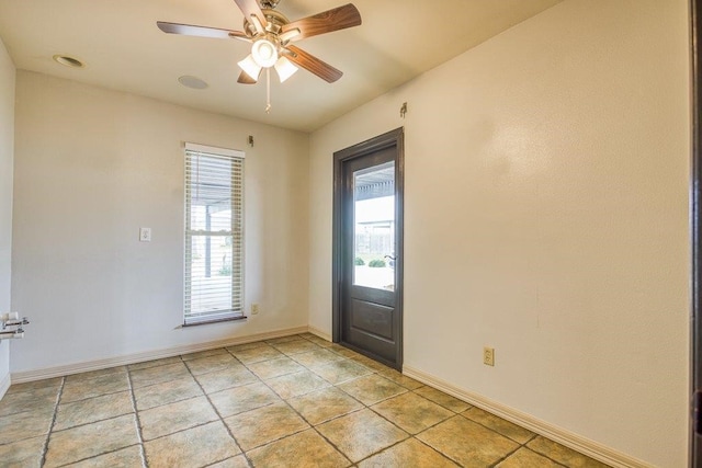 foyer entrance featuring light tile patterned floors and ceiling fan