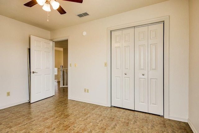 unfurnished bedroom with ceiling fan and a closet