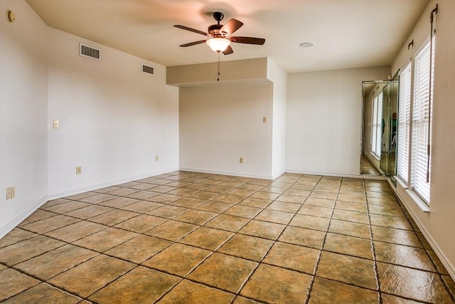 unfurnished room with a wealth of natural light and ceiling fan