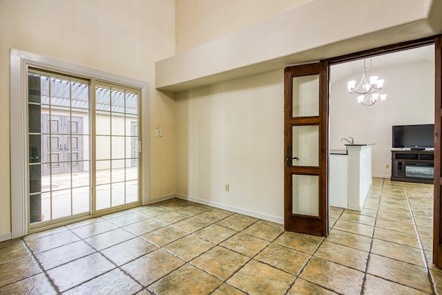 empty room with a chandelier and a high ceiling