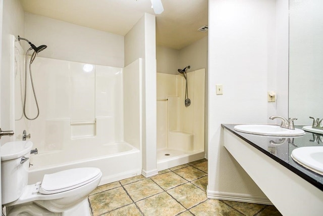 bathroom with toilet, vanity, and tile patterned flooring