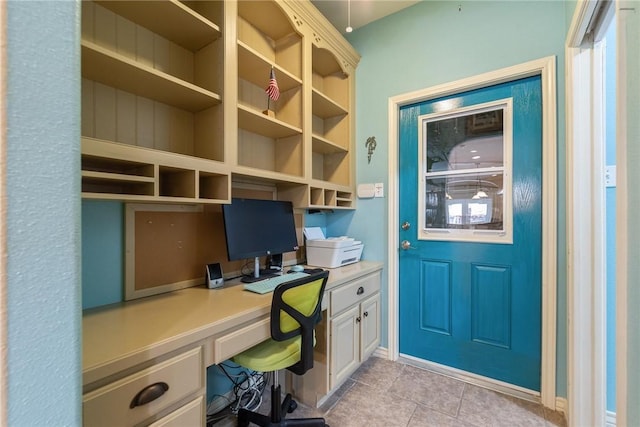 home office featuring light tile patterned floors and built in study area