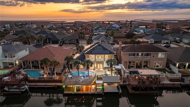 drone / aerial view featuring a water view and a residential view