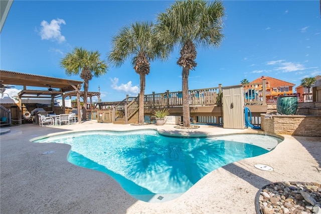 outdoor pool with a patio area and a pergola