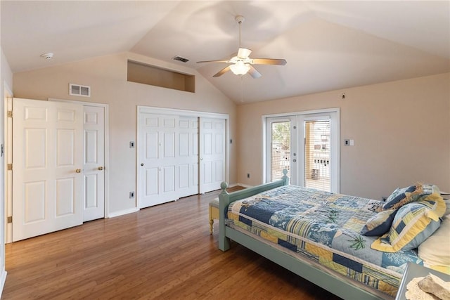 bedroom with lofted ceiling, access to outside, wood finished floors, and visible vents