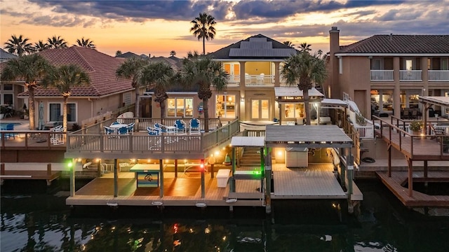 back of house at dusk with boat lift