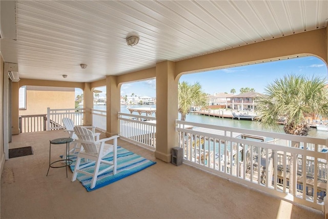 view of patio / terrace featuring a water view and a balcony