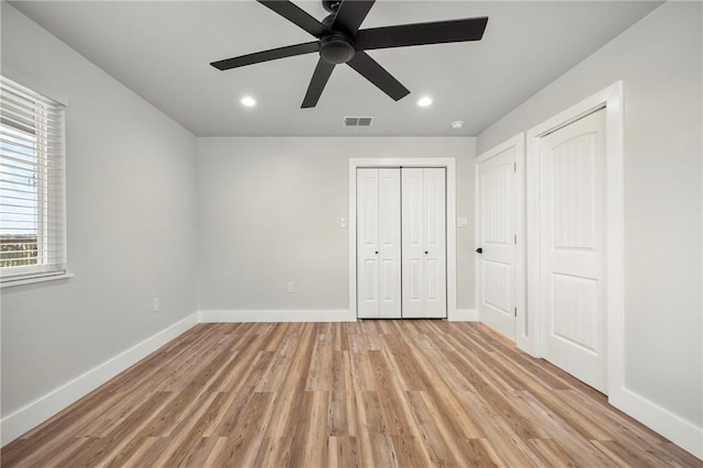 140 Port Saint Claire, Aransas Pass, TX 78336 - unfurnished bedroom with light wood finished floors, baseboards, recessed lighting, multiple closets, and ceiling fan